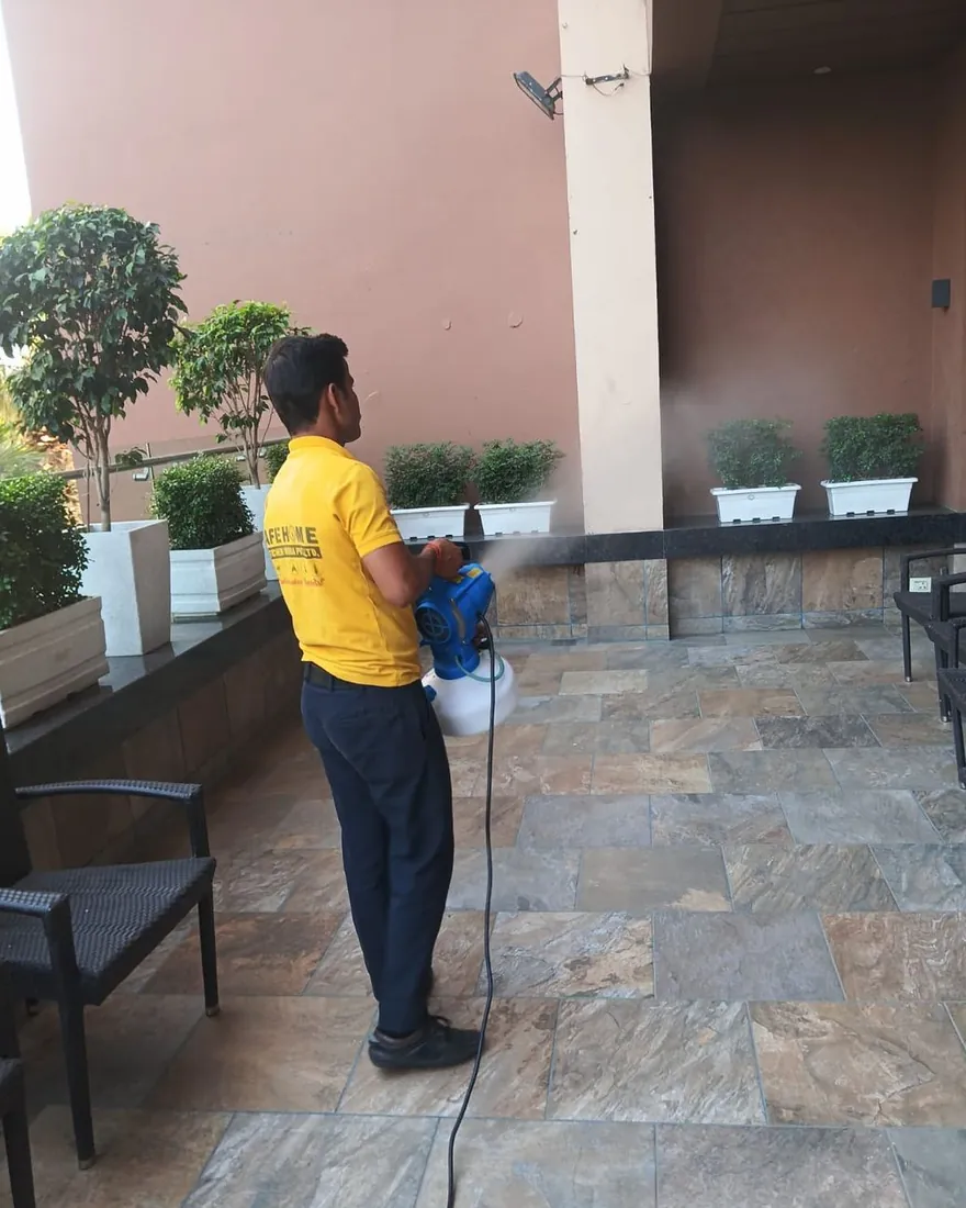 Safe Home Pestochem technician: perimeter treatment at a hotel entrance