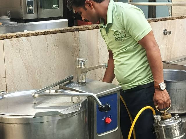 Treating commercial kitchen equipment in a food preparation area