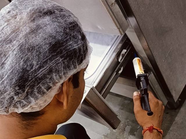 Inspecting kitchen equipment for cockroach harbourage