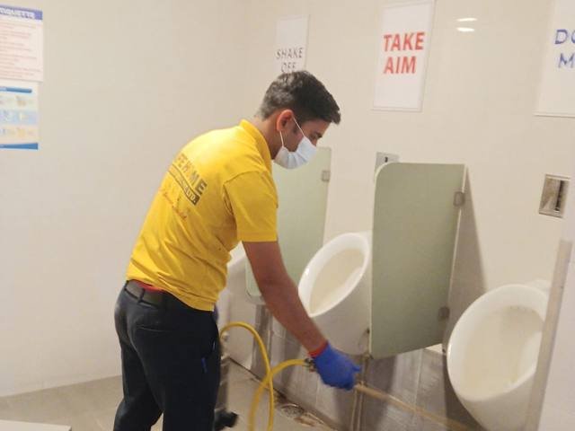 Washroom treatment and disinfection in a commercial building